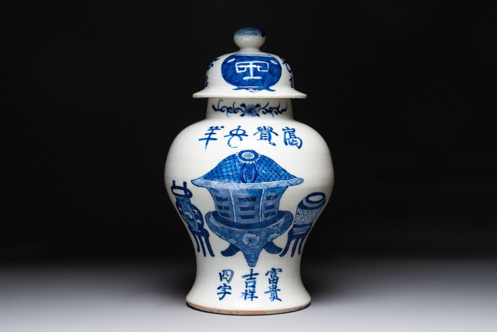 A Chinese blue and white vase and cover with calligraphy and antiquities, 19th C.