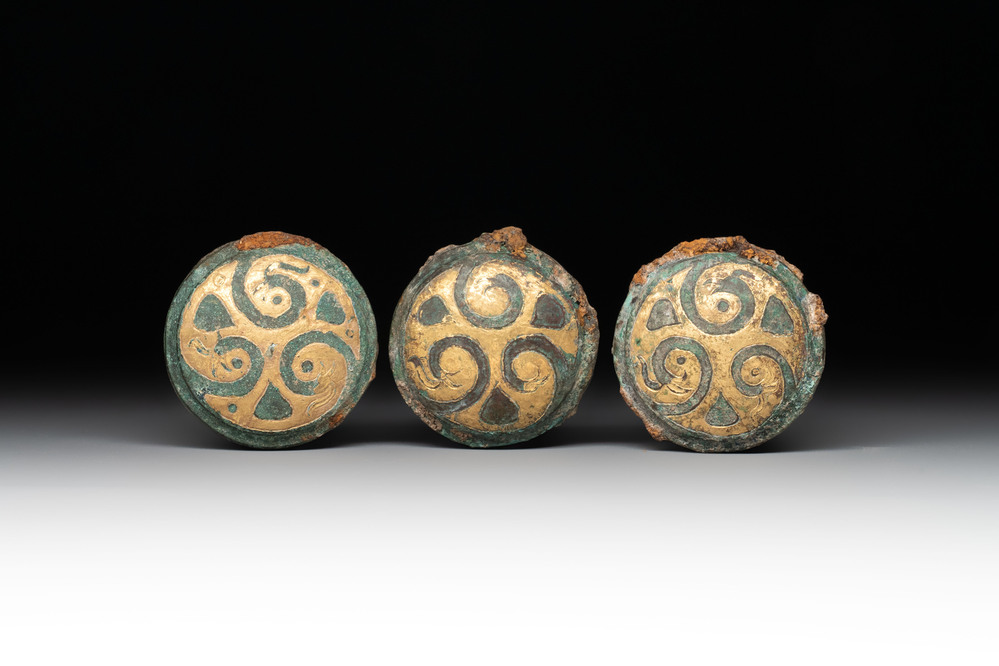 Three Chinese gilt-bronze ornaments with 'thunder' design, Han