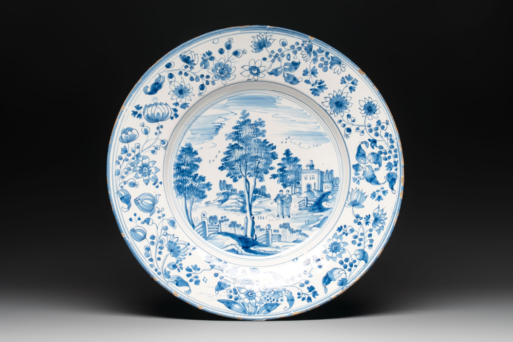 A large blue and white 'landscape and figures' dish, Frankfurt, 17th C.