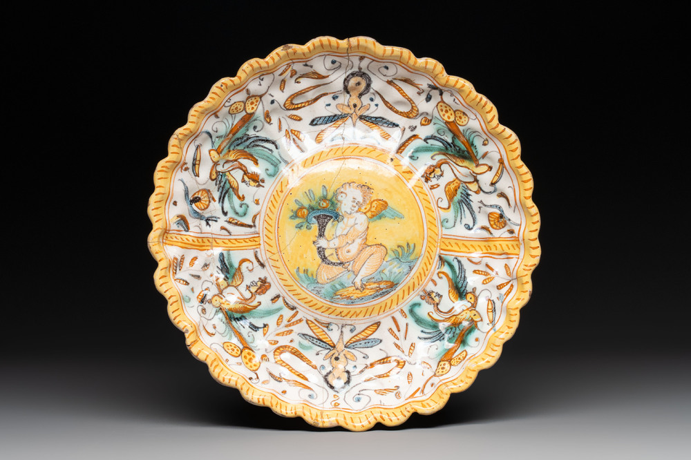 A polychrome Italian maiolica plate with a putto, Deruta, 17th C.