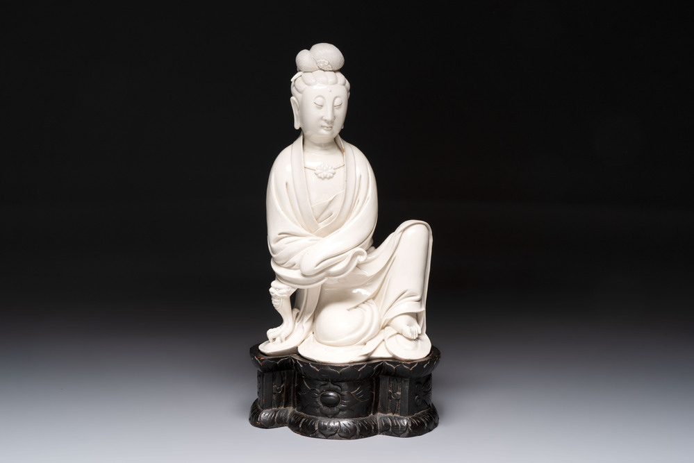 A rare and elegant Chinese Dehua blanc de Chine Guanyin on a wooden stand, Transitional period