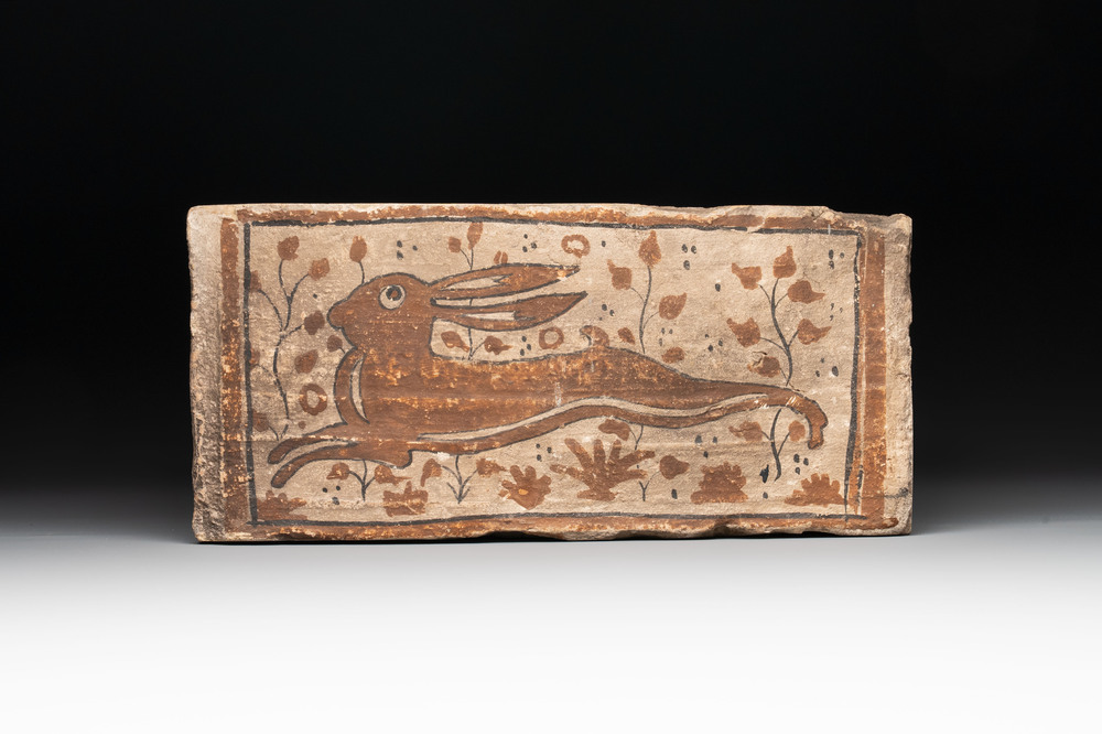 A Spanish cold-painted 'socarrat' or ceiling tile with a hare, 15th C.