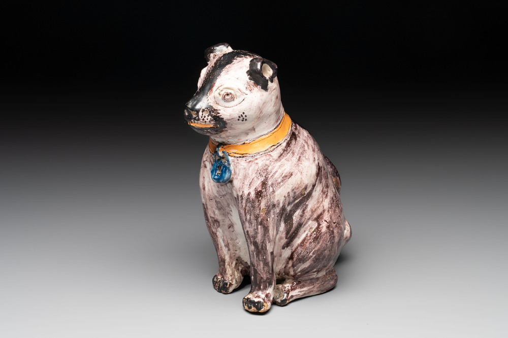 A polychrome Brussels faience model of a dog, 18th C.