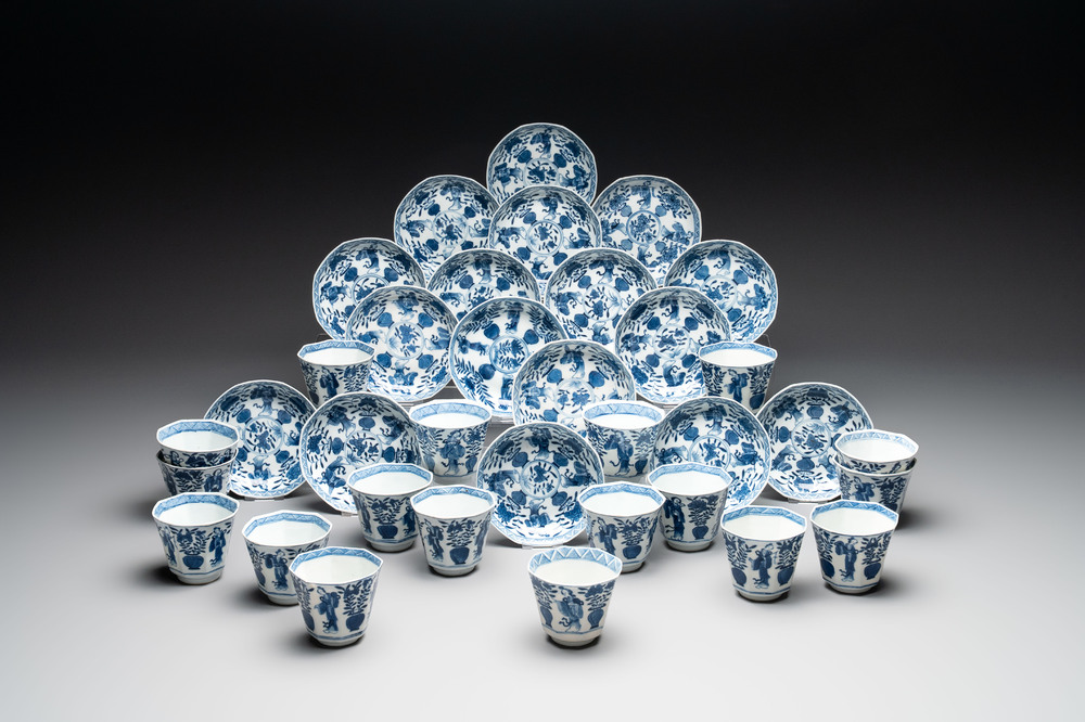 A collection of 18 Japanese blue and white cups and 17 saucers with figural and floral design, 19th C.