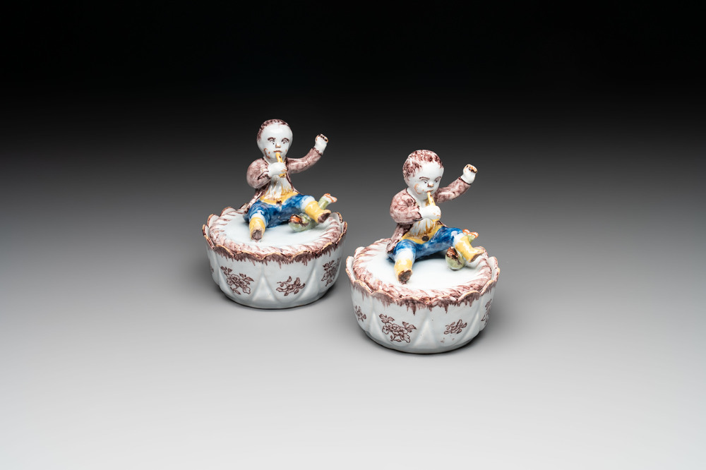 A pair of polychrome Dutch Delft fluting-children-topped butter tubs and covers, 18th C.