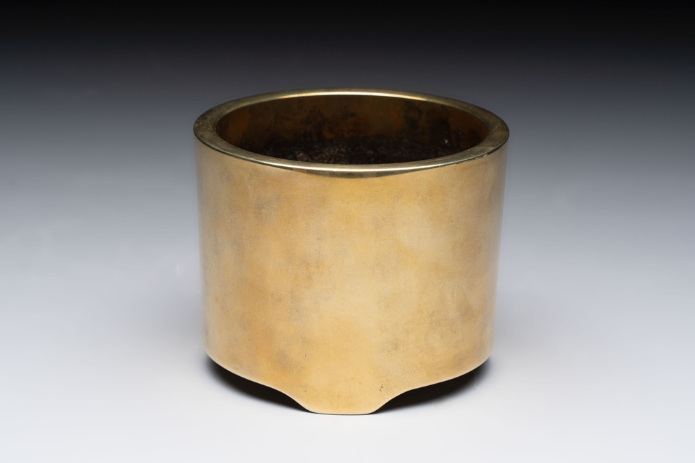 A Chinese bronze cylindrical tripod censer, Xuande mark, 18th C.