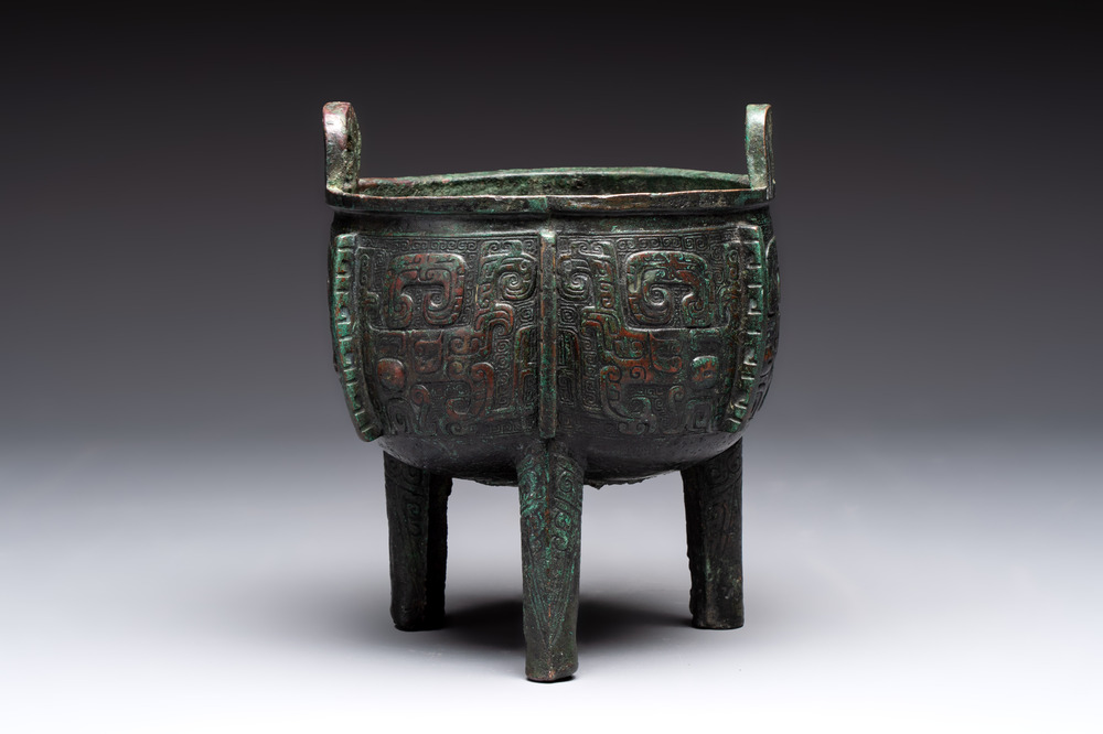 A Chinese archaic bronze tripod food vessel with 'taotie' design, 'ding 鼎', Western Zhou