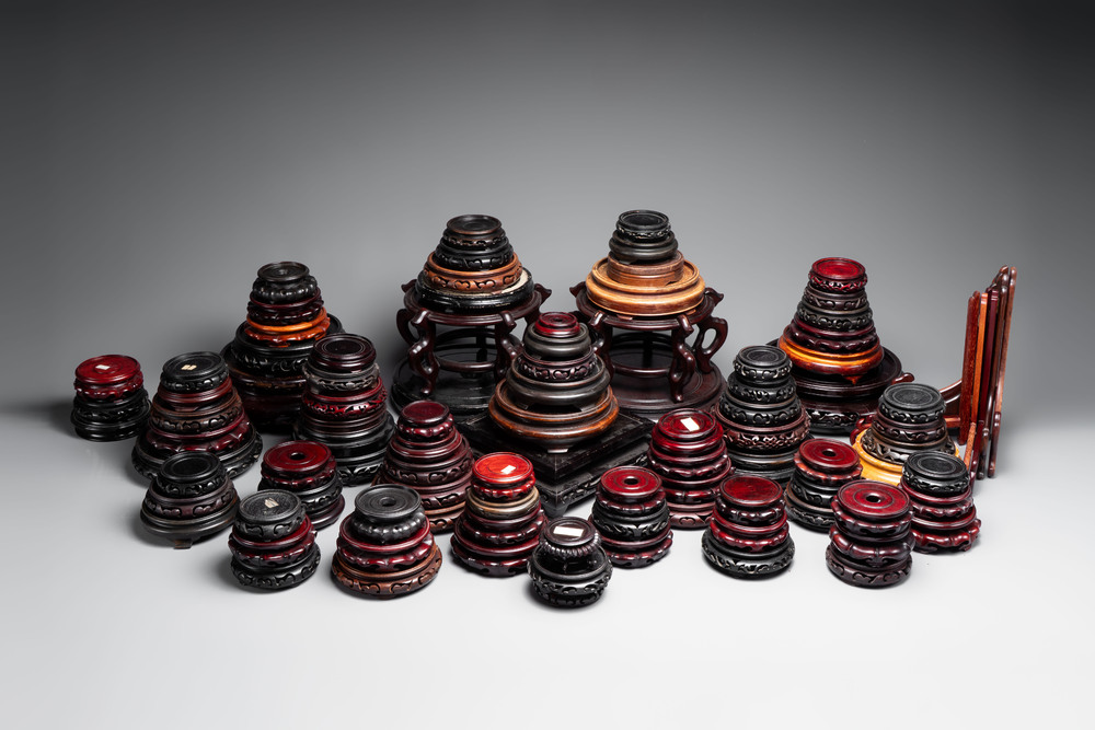 A collection of 100 Chinese wooden stands, 19/20th C.