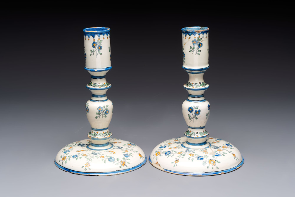 A pair of polychrome French faience candlesticks, 18th C.