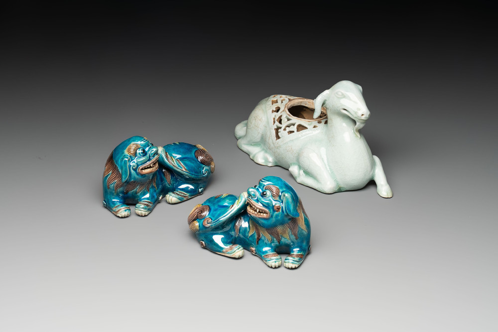 A pair of Chinese polychrome lions and a celadon-glazed goat, 20th C.