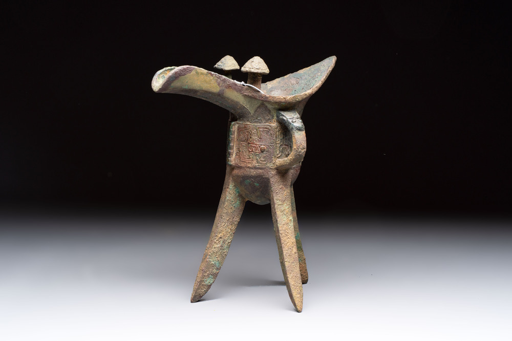 A Chinese archaic bronze wine vessel with taotie design, 'jue 爵', Zhou