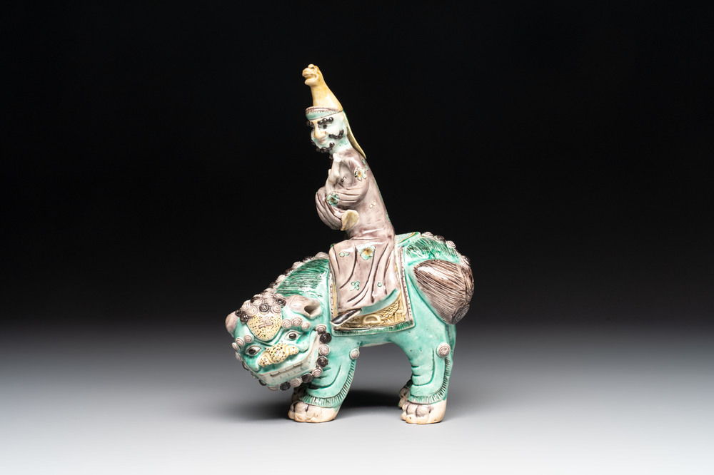 A Chinese verte biscuit 'Sogdian riding a Buddhist lion' group, 19th C.