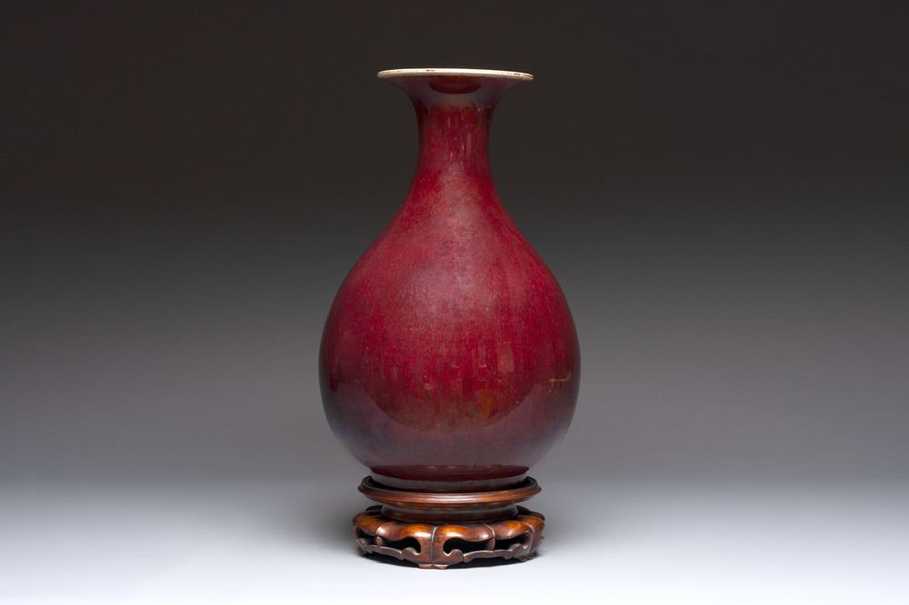A large Chinese flamb&eacute;-glazed 'yuhuchunping' vase on a wooden stand, 19th C.