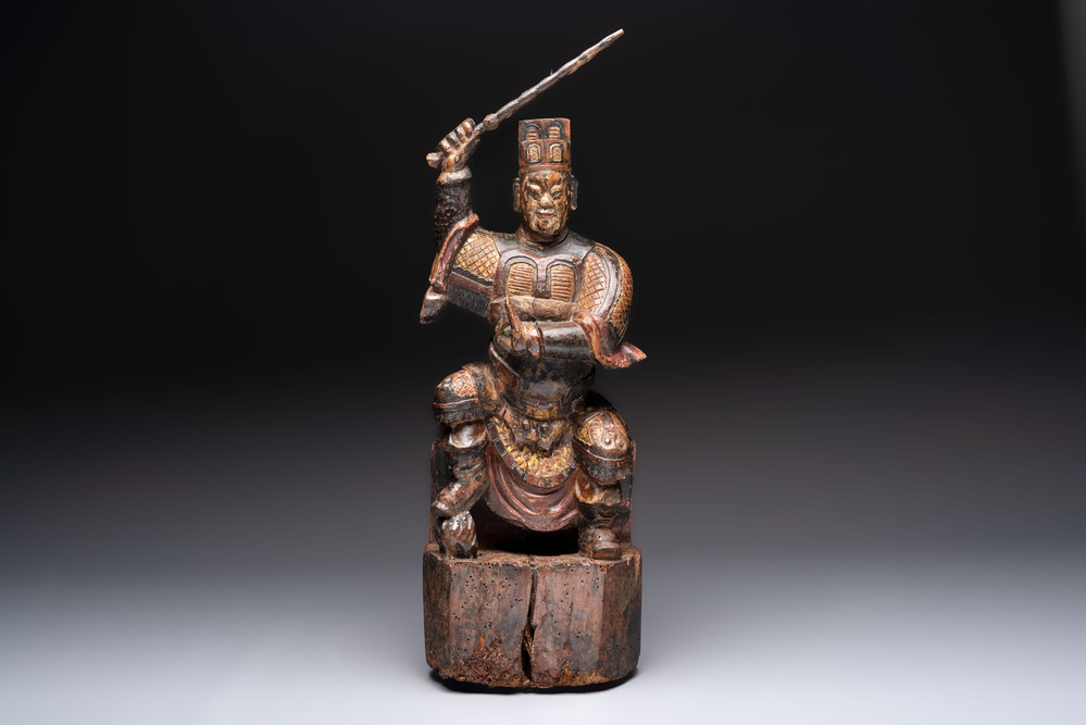 A Chinese gilt-lacquered wooden sculpture of a guardian, 19th C.
