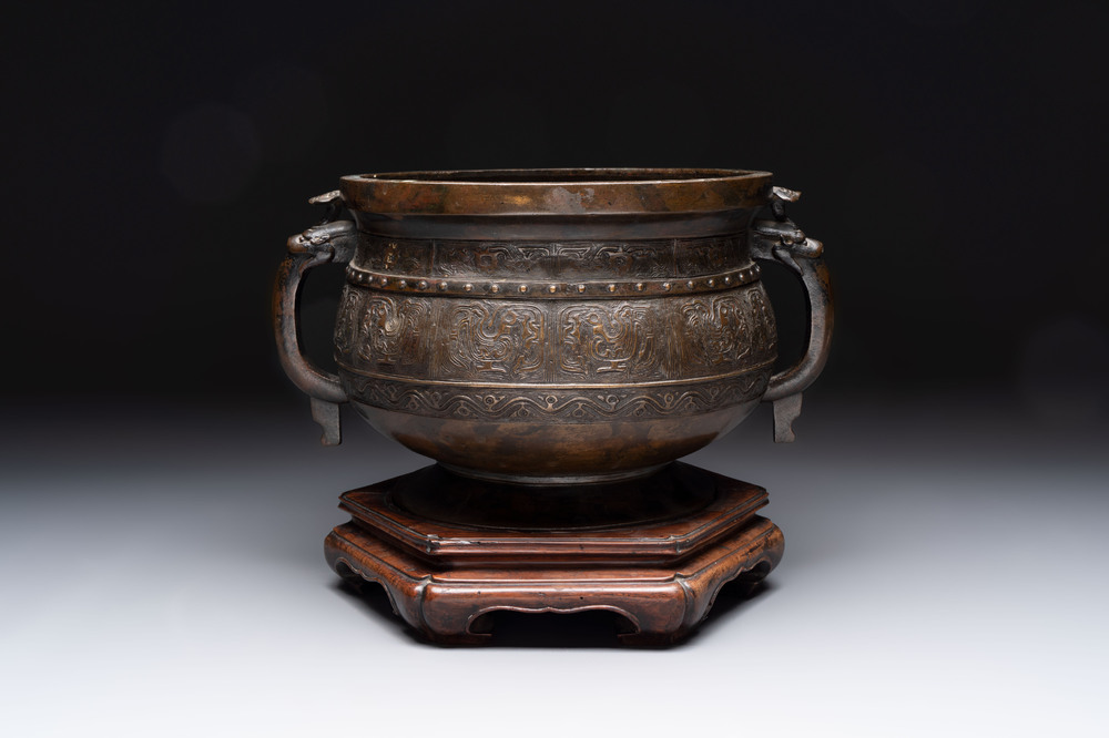 A Chinese archaistic bronze censer with 'chilong' and 'lingzhi' handles on wooden stand, Zhou Wang Bo Zuo Bao Ding 周王伯作寶鼎 mark, Yuan/Ming