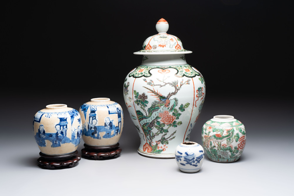 A Chinese famille verte covered vase, a pair of blue and white jars on wooden stands and two jars, 19th C.