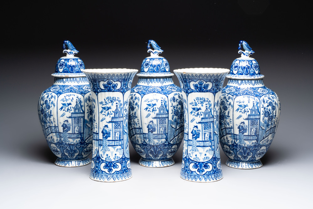 A blue and white Dutch Delft garniture of five vases and covers, 19th C.