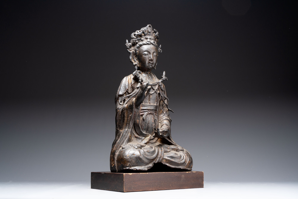 A large Chinese bronze Bodhisattva on wooden stand, Ming