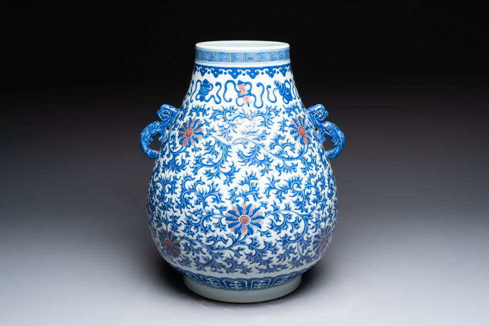 A Chinese blue, white and copper-red 'hu' vase with lotus scrolls, Qianlong mark, 19th C.