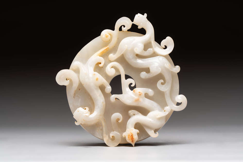 A Chinese carved white and russet jade bi-disc with chilong design, 19/20th C.