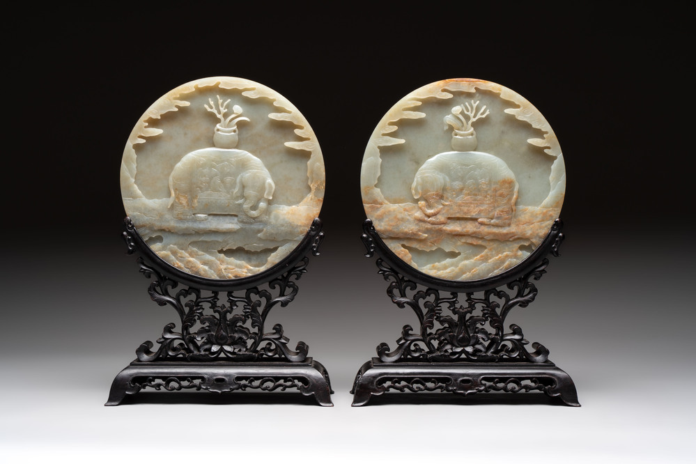 A pair of Chinese carved jade &lsquo;elephant&rsquo; plaques on wooden stands, 19th C.