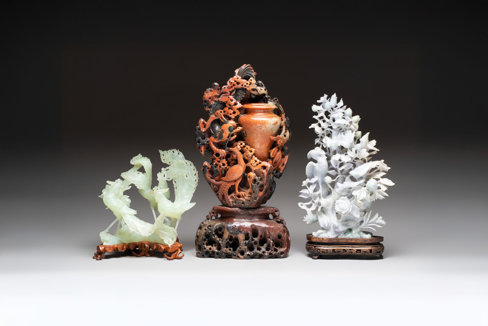 A Chinese soapstone vase with stand and two jadeite carvings on wooden stands, 19/20th C.