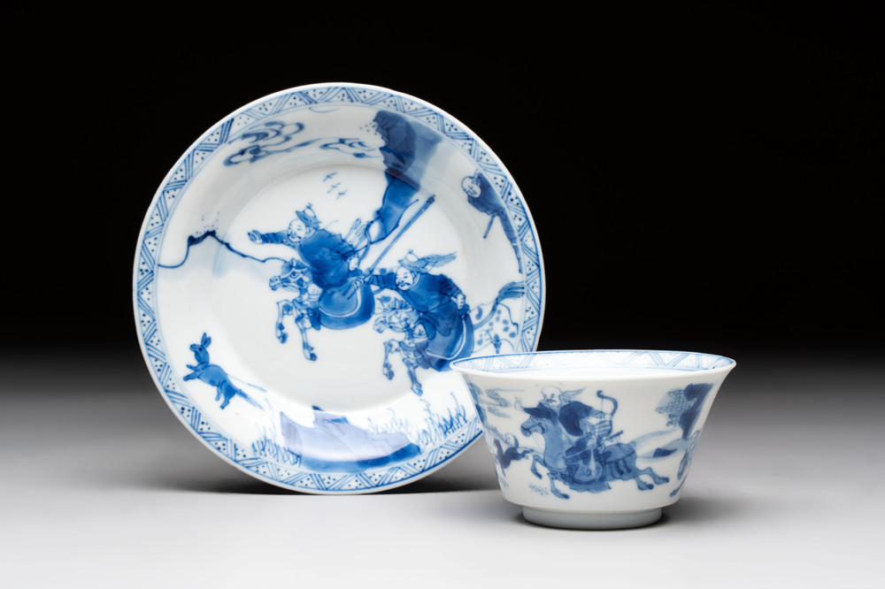 A Chinese blue and white 'Mongolian hunting' cup and saucer, jade mark, Kangxi