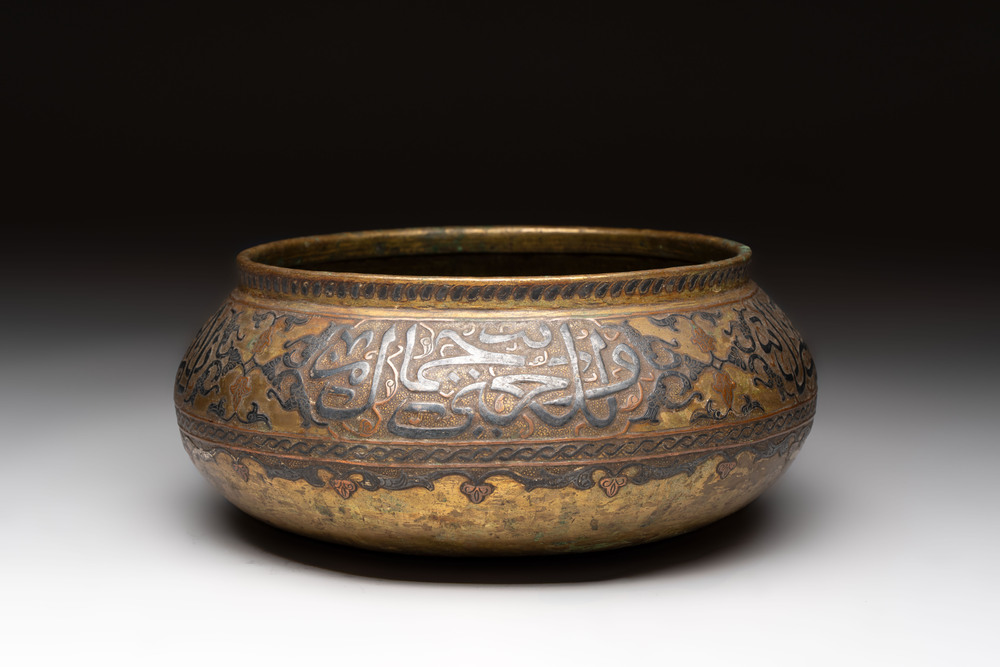 A Persian silver- and copper-inlaid 'calligraphic' brass bowl, 18th C.