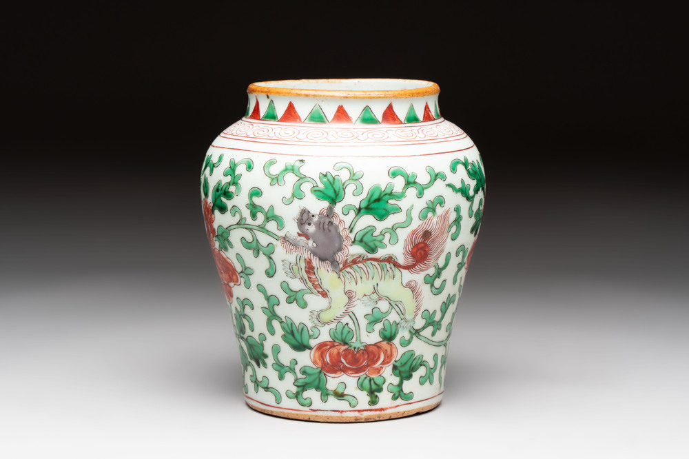 A small Chinese wucai 'Buddhist lion and peony scrolls' jar, Transitional period
