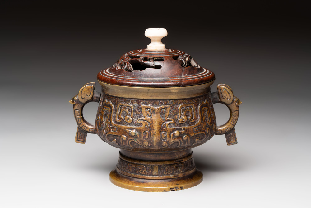 A Chinese archaistic bronze censer with a wooden cover, Xuande mark, 19th C.