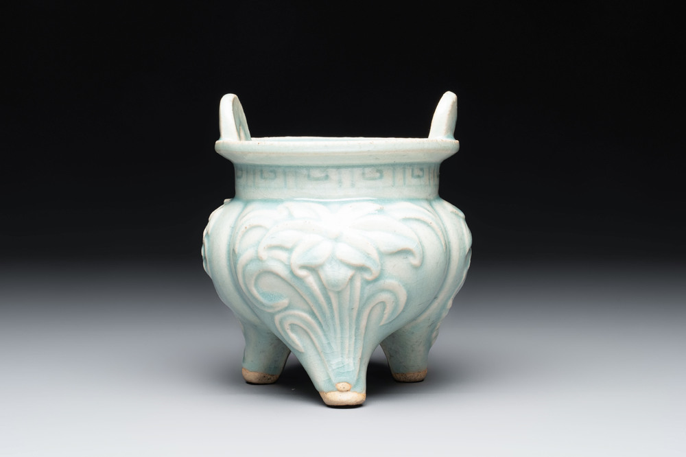 A Chinese qingbai tripod censer with floral relief design, Song/Yuan