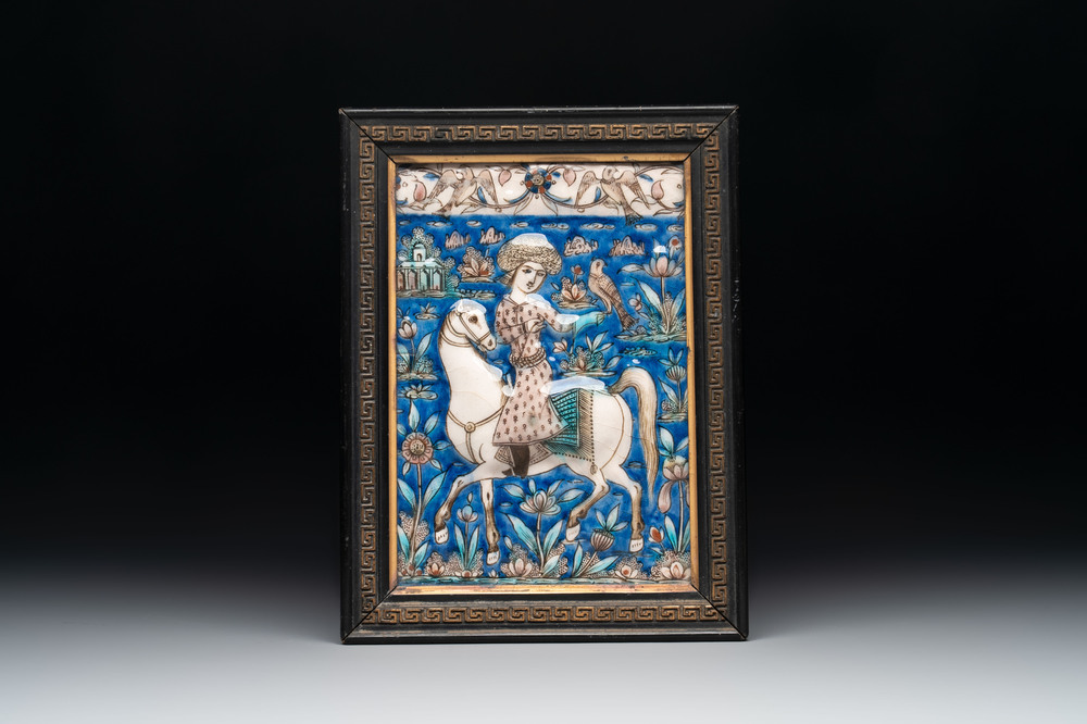 A rectangular Qajar relief-moulded tile with a falconer on horseback, Iran, 19th C.