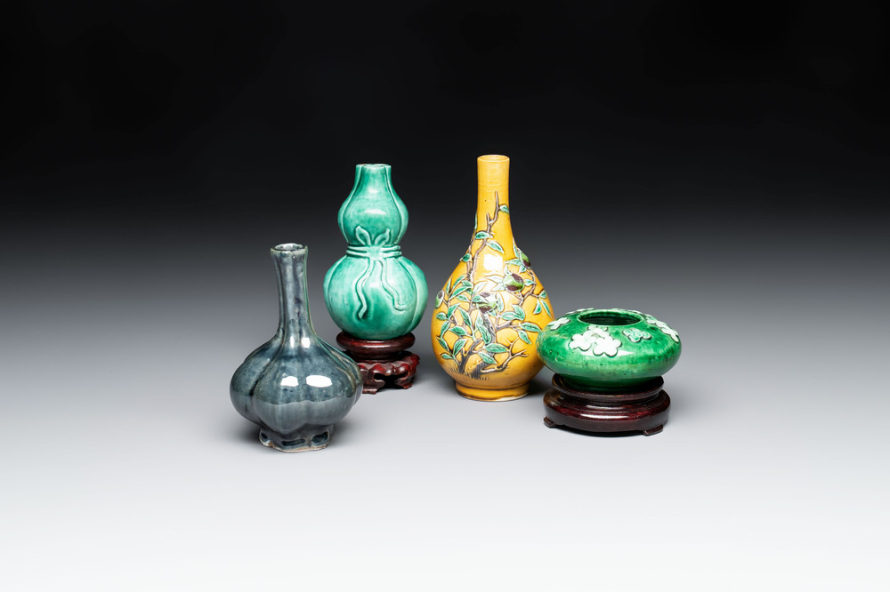 Four Chinese monochrome wares and two wooden stands, 19th C.