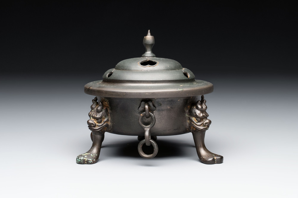 A Chinese bronze tripod censer and cover, Sui/Tang