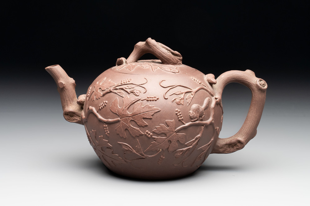 A Chinese Yixing stoneware 'squirrels among grapevines' teapot and cover, Kangxi