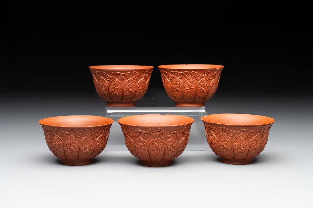 A set of five Chinese Yixing stoneware cups with floral design, Kangxi