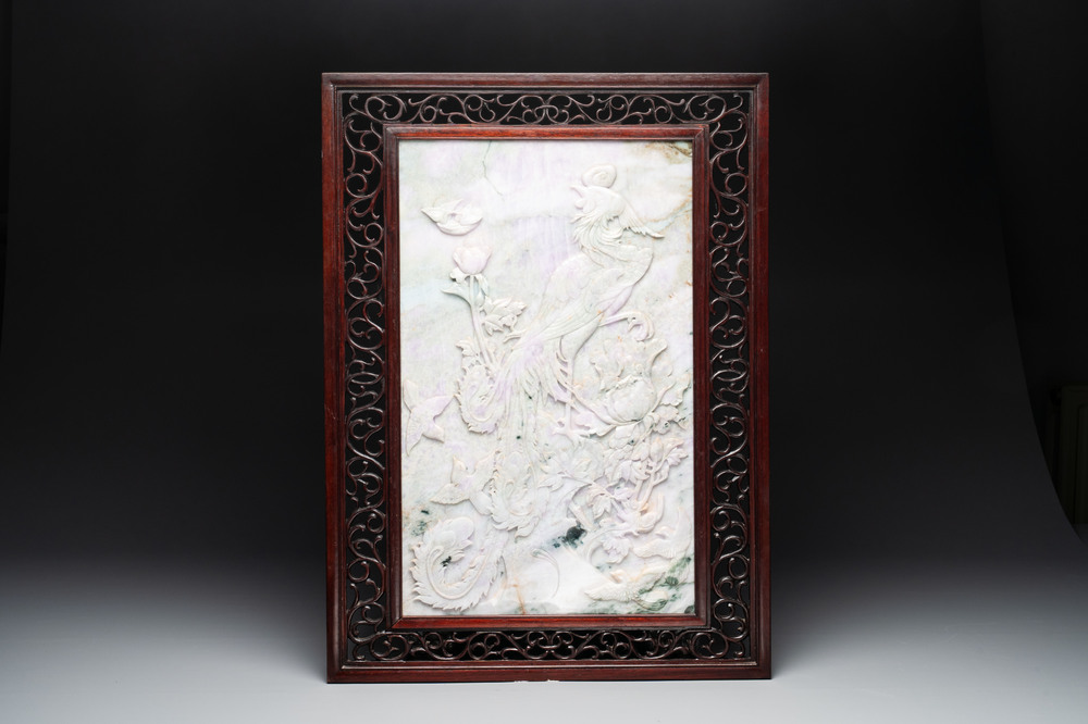 A Chinese lavender and green jadeite 'phoenix' plaque in a hongmu frame, early 20th C.