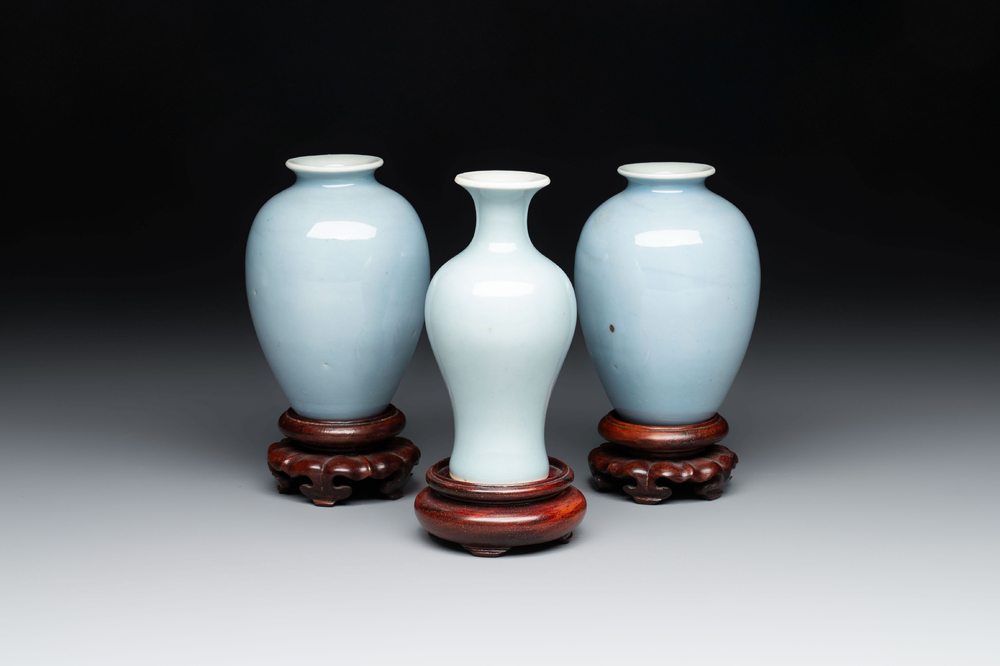 Three Chinese claire-de-lune vases on wooden stands, Kangxi mark, 19th C.