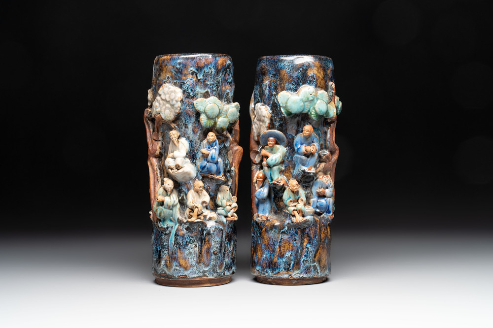 A pair of Chinese Shiwan polychrome hat stands with haut-relief figural design, 19/20th C.