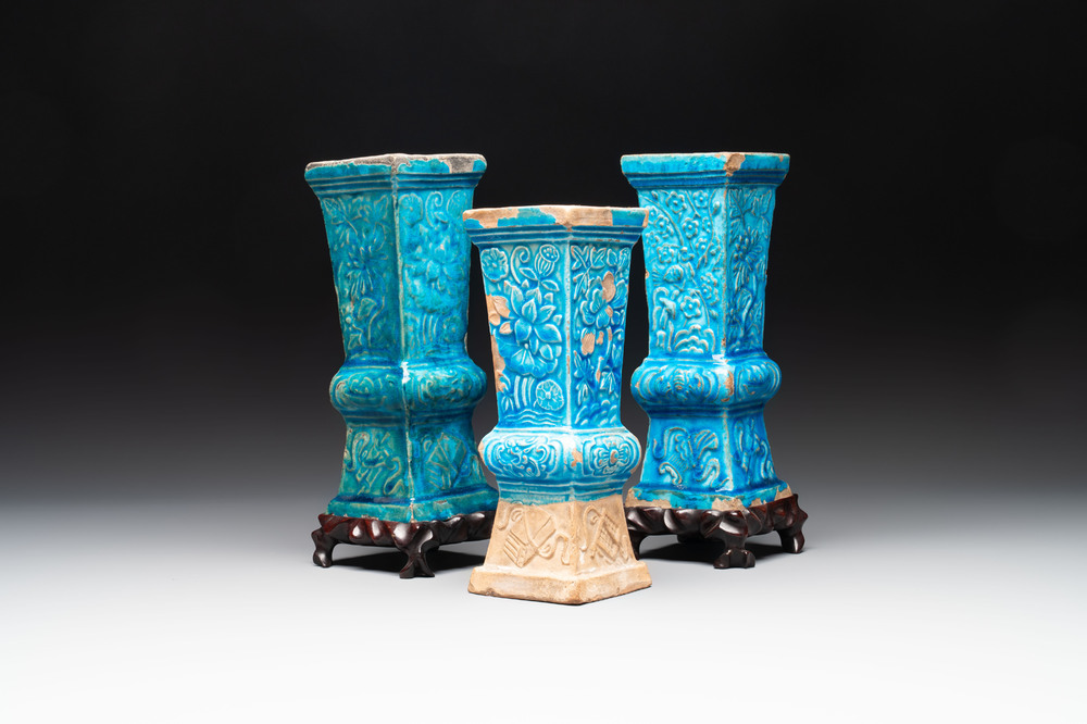 Three Chinese turquoise-glazed 'gu' vases with floral design, two with wooden stands, Ming