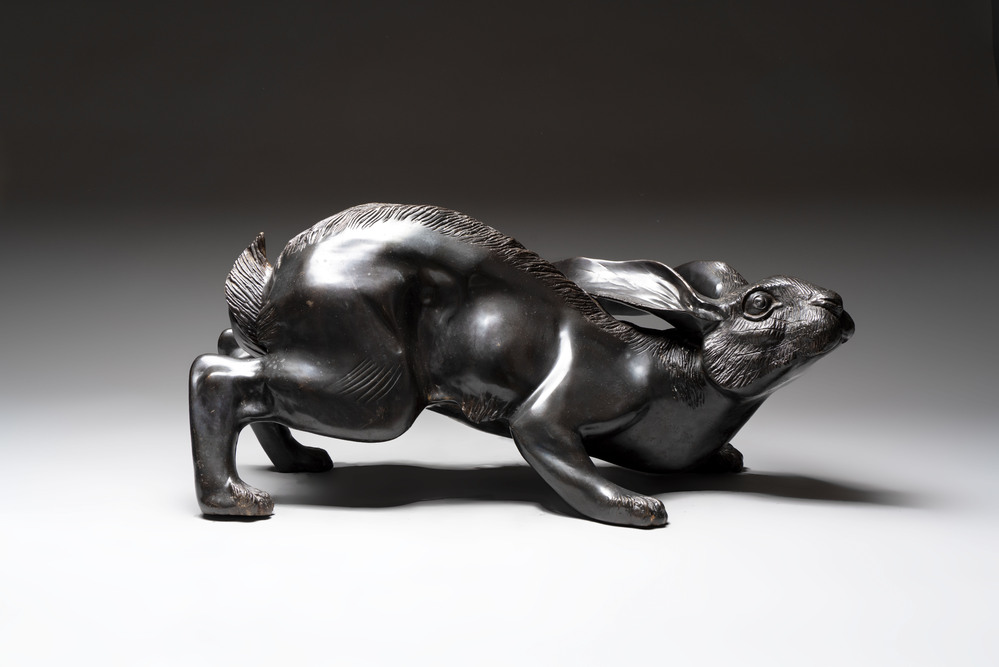 A large Japanese bronze sculpture of a reclining hare, 20th C.