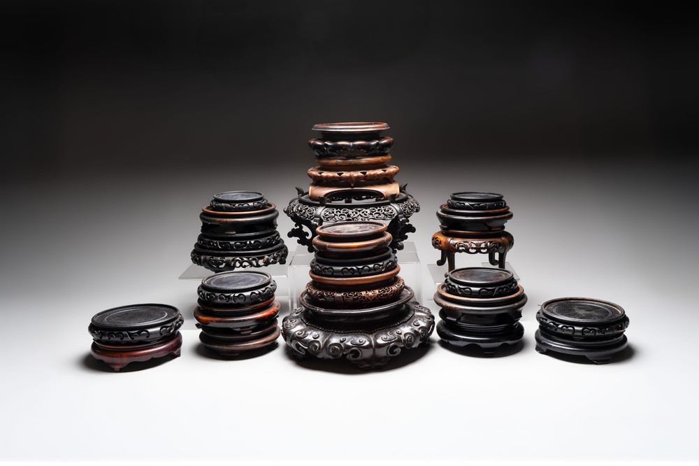 A collection of 25 Chinese wooden stands, 19/20th C.