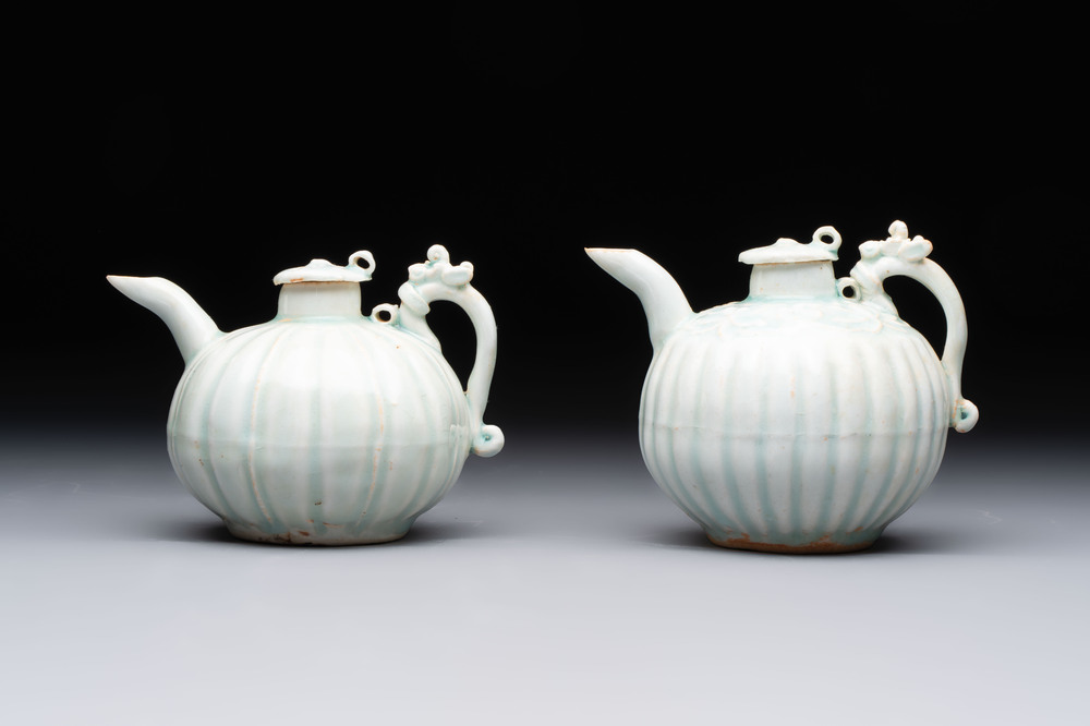 A pair of Chinese qingbai ewers and covers with dragon-form handles, Song/Yuan
