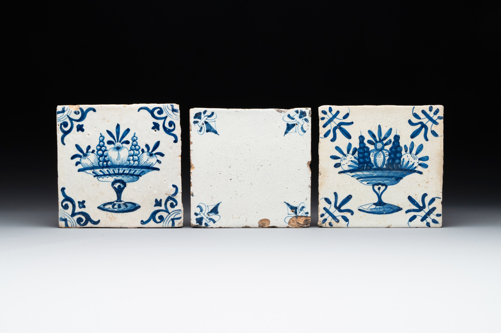 A rare 'empty' blue and white Dutch Delft tile and two 'fruit bowl' tiles, 17th C.