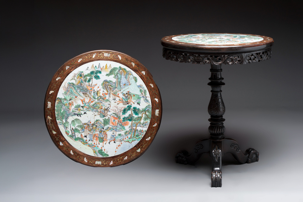 A Chinese mother-of-pearl-inlaid hongmu table with a circular Canton famille verte 'warriors on horseback' plaque, 19th C.