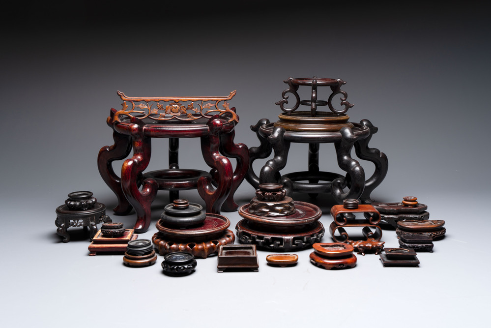 A collection of 30 Chinese wooden stands, 19/20th C.