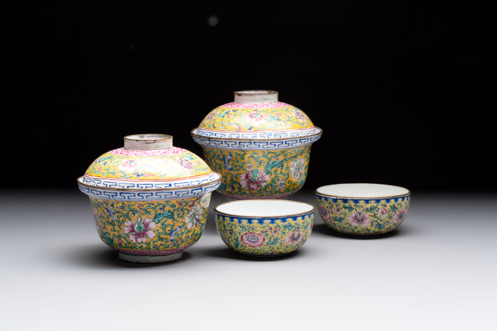 A pair of Chinese yellow-ground Canton enamel covered bowls and two cups, Yongzheng/Qianlong