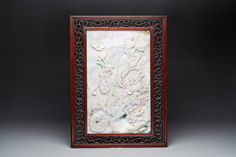 A Chinese lavender and green jadeite 'phoenix' plaque in a hongmu frame, early 20th C.