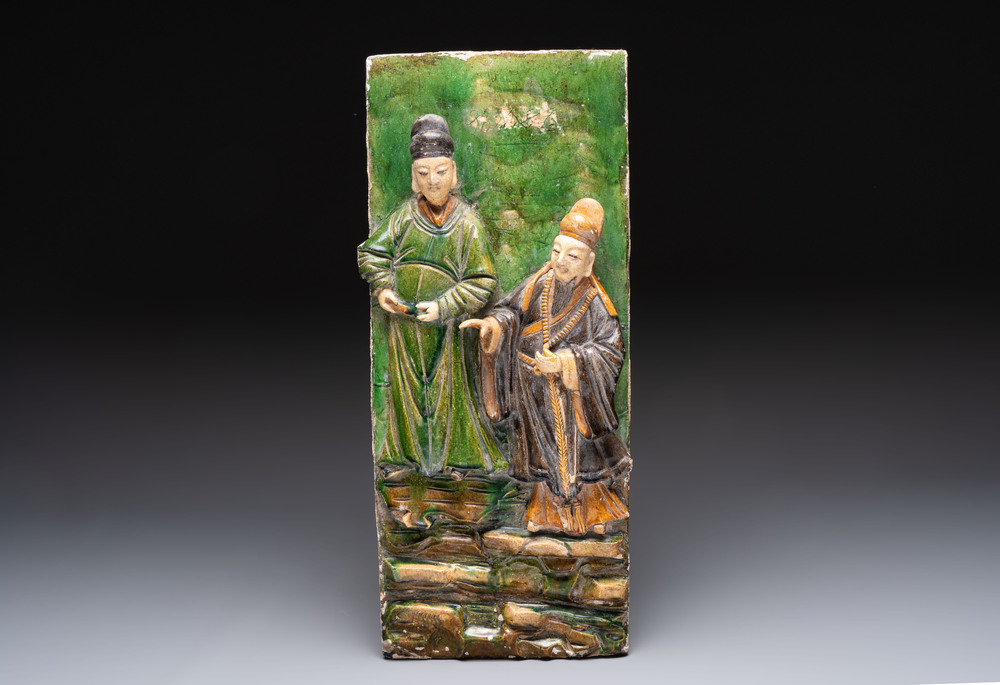 A large Chinese sancai-glazed architectural tile with two figures, Ming