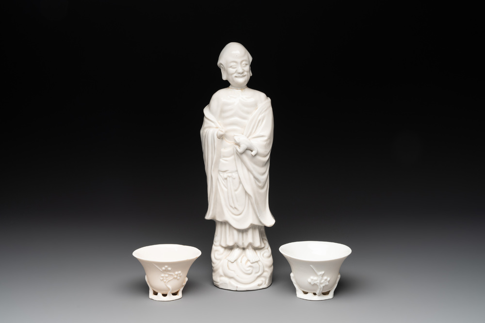 Two Chinese Dehua blanc de Chine wine cups and a figure of Liuhai, 18/19th C.